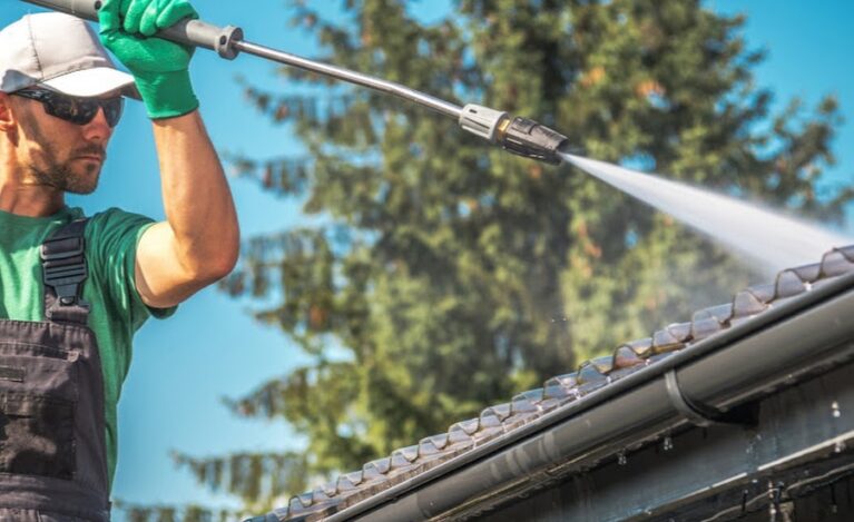 Washing Plastic Transparent Carport Roof by Caucasian Men. Pressure Washer Job.